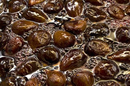 Fig jam. Cooked Fig jam with fruit berries in liquid jelly, close-up.の写真素材
