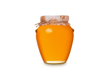Glass pot full of honey bee closed paper lid isolated on white backgroundの写真素材