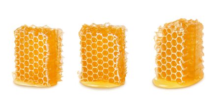 Three pieces of bee honeycomb with liquid honey isolated on white background, natural apicultureの写真素材