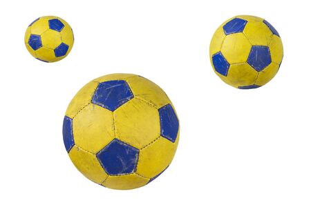 Old yellow soccer ball isolated on white backgroundの写真素材