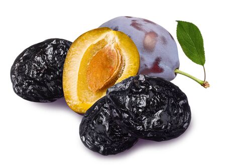 Fresh and dried whole plum with half and green leaves isolated on white backgroundの写真素材