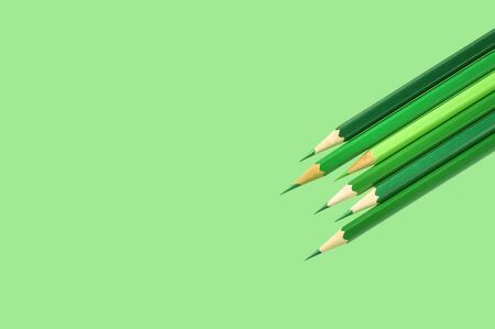 Green pencil on a green backgroundの写真素材