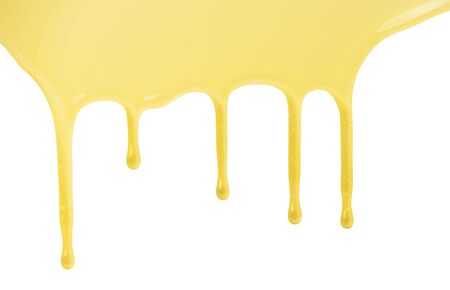 Liquid sweet flowing honey drops isolated on white backgroundの写真素材