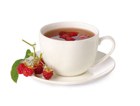 Raspberry tea. Black tea hot drink in Cup with saucer and healthy red raw raspberry berry and leaf isolated on white backgroundの写真素材
