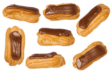 Isolated eclairs set with custard and chocolate icing on white background. Traditional french...