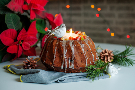 Christmas festive pound cake decorated with fruits and berries on tableの写真素材