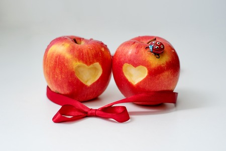 Love of apples concept with a neatly incised heart in the skin of a ripe red apple in St. Valentina's Dayの写真素材