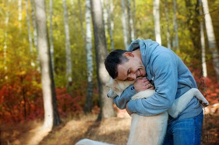 Young man and his dog - man's best friendの写真素材