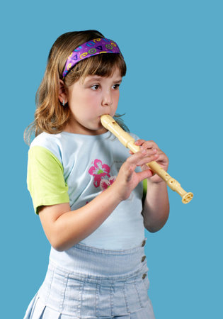  little girl playing the fluteの写真素材