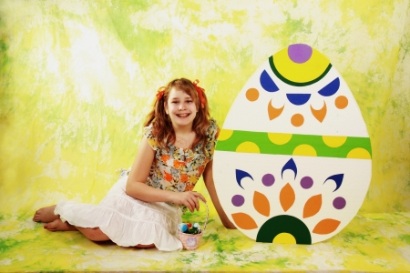 Girl and Easter eggs on color backgroundの写真素材