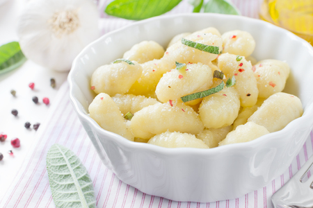 Delicious italian gnocchi with sage leaves and olive oilの写真素材