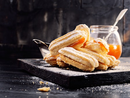 Shortbread butter cookies with apricot jam  on  black wooden background with free text space. Selective focus.の写真素材