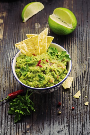 Guacamole  in  wooden bowl on black  board. Selective focus.の写真素材