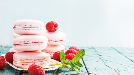 Pink macaroons,macarons with rasberry on liht wooden background,selective focusの写真素材