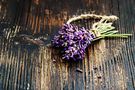 Bunch of lavender flowers on a black wooden background, copy space .の写真素材