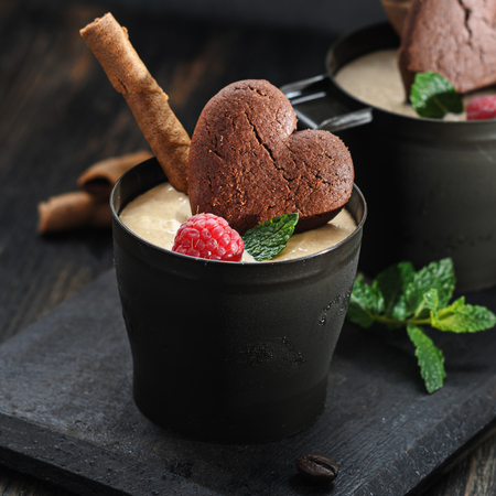Cofffe ice cream with rasberries on black wooden background, free text space.の写真素材