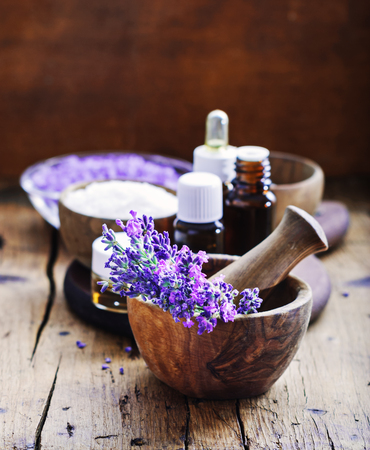 Lavender spa , bunch of lavender flowers , essential oil and salt on a rustic wooden background.の写真素材