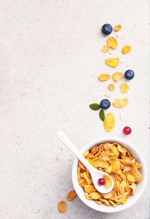 Background healthy concept bowl with corn flakes and fresh berries on a marble surface  with free text space .の写真素材