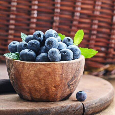 Blueberry in wooden bowl on rustic background.の写真素材