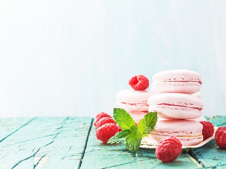 Pink macaroons,macarons with rasberry on liht wooden background,selective focusの写真素材