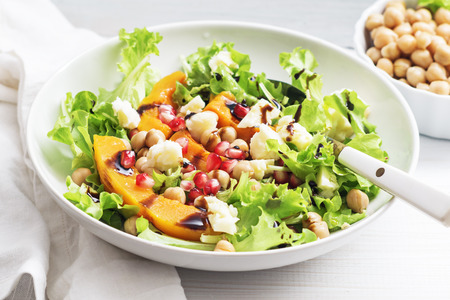 Fall pumpkin salad with chickpeas and cheese and pomegranate seedsの写真素材