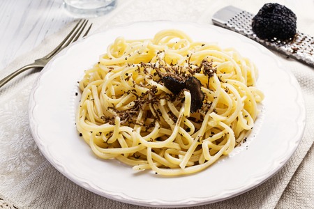 Strangozzi, italian wheat pasta with truffle on a light background.の写真素材