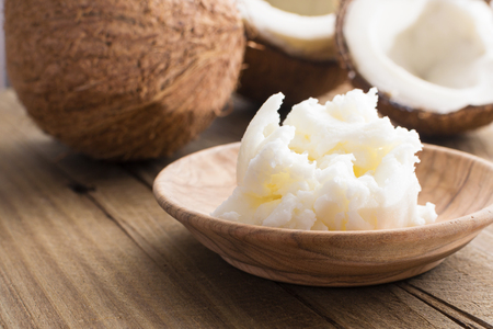 coconut butter and milk on wooden background. Organic healthy food concept. Beauty and SPA concept.の写真素材