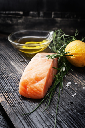 Fish  for healthy seasonal cooking ,black wooden background.の写真素材