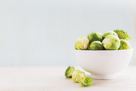 Ingredients Brussels Sprout with Broccoli, kale, and carrot on black wooden table. Selective focusの写真素材