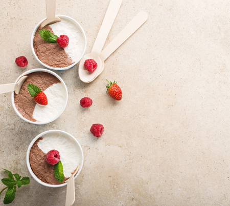 Chocolate vanilla ice cream with summer berries on marble table. Top view copy space.の写真素材