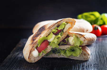 Puccia salentina- traditional Italian flatbread with tomatoes and mozzarella, Puglia.の写真素材