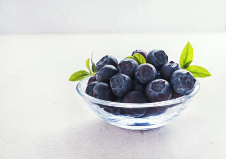 Blueberry in glass bowl on  white rustic background.の写真素材