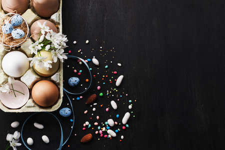Food art idea for  Easter holiday baking background.Decorative eggs,vanilla bean, spring flowers, top view free text spaceの写真素材