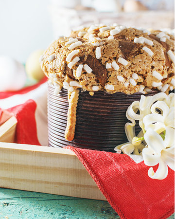 Colomba - italian easter dove cake on old rustic cyan wooden board. Selective focus, free text...