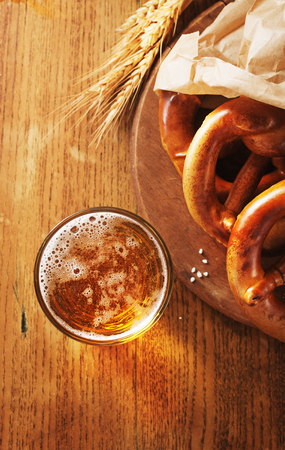 Salted pretzels for Oktoberfest on old  wooden board  with free text space.の写真素材