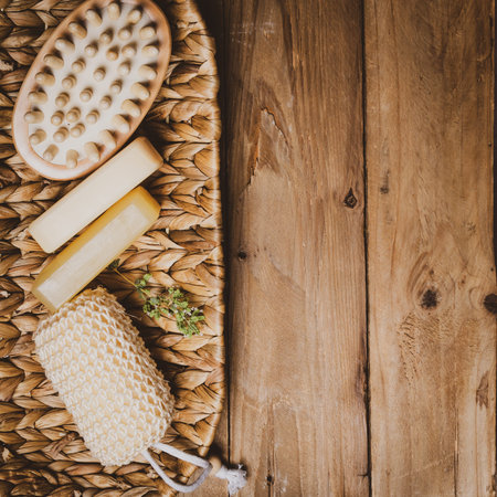 Kit of soap and natural massage  washcloth on wooden background.