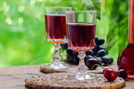 Ratafia - tipical Italian sweet alcoholic beverage, either a fruit-based beverage or a fortified wine with cherries. Rustic style.の写真素材