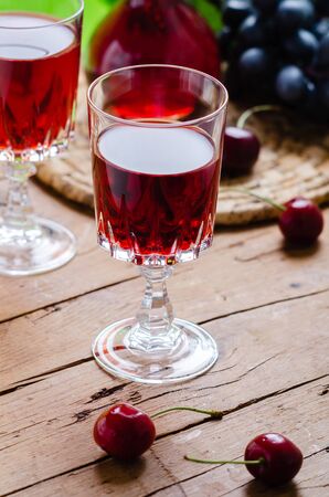 Ratafia - tipical Italian sweet alcoholic beverage, either a fruit-based beverage or a fortified wine with cherries. Rustic style.の写真素材