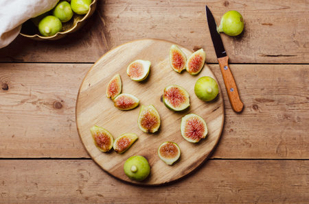 Ripe figs fruit on a wooden board.