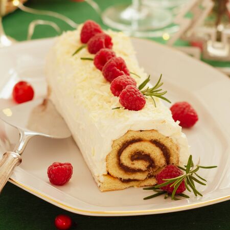 White chocolate cream yule log Christmas cake with  raspberries.の写真素材