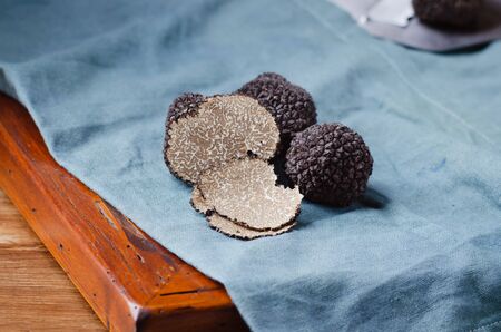 Black truffles  mushrooms on rustic wooden table with free text spaceの写真素材