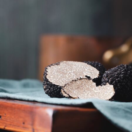 Black truffles  mushrooms on rustic wooden table with free text spaceの写真素材