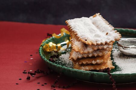 Typical carnival fritters dusted with powdered sugar on   table.の写真素材