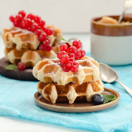 Breakfast with belgian waffles with honey caramel sauce and summer berriesの写真素材