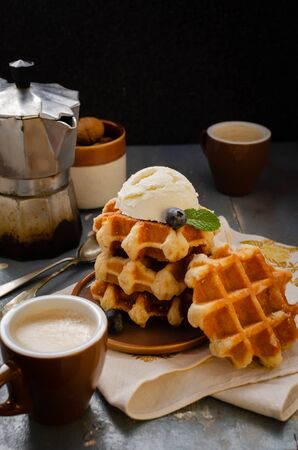 Breakfast with belgian waffles with honey  and blueberriesの写真素材