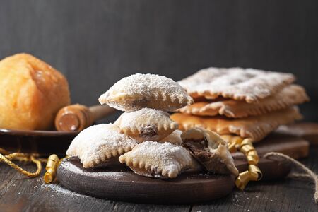 Ravioli filled with chocolate, carnival Italian fritters on dark rustic board.の写真素材