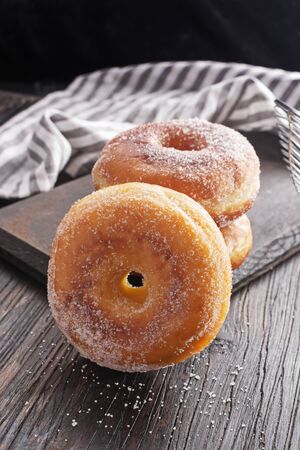 Donuts on black wooden table.の写真素材
