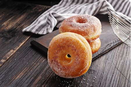 Donuts on black wooden table.の写真素材
