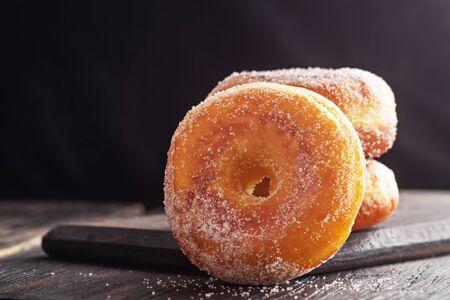 Donuts on black wooden table. Copy spaceの写真素材