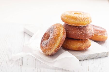 Donuts on white wooden table. Copy spaceの写真素材